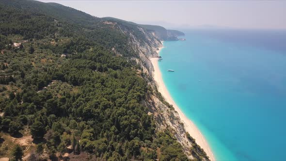 Young man shooting the drone above Egremni beach one of the most beautiful beaches the world