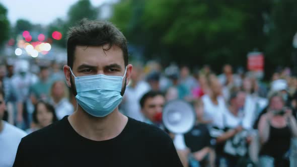 Coronavirus Epidemic Demonstration Masked Activist Marches in City Street Crowd alt