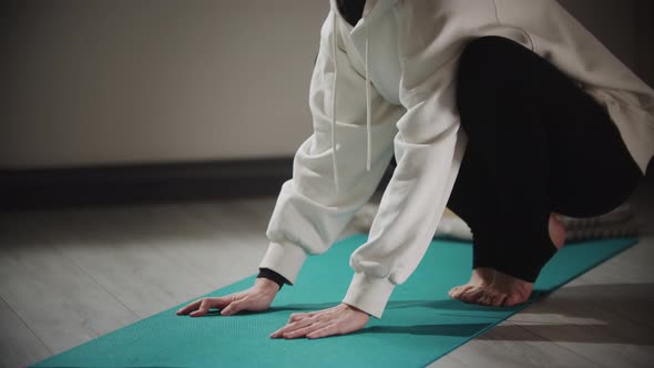 Yoga  Strong Woman in Hijab Does Exercises on Yoga Mat alt