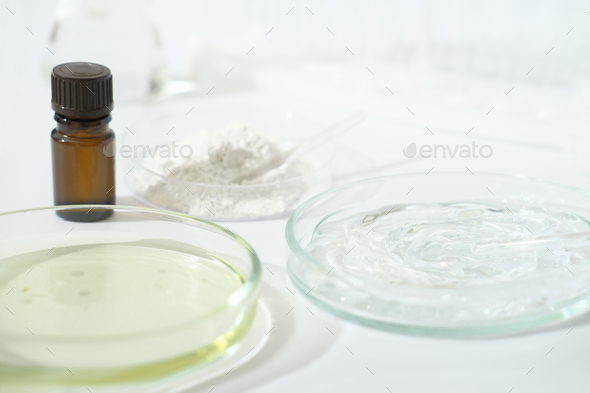 laboratory petri dishes with growth medium or culture medium and powder on a table.