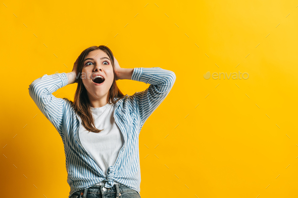 Portrait of excited young woman surprised by something expresses shock ...