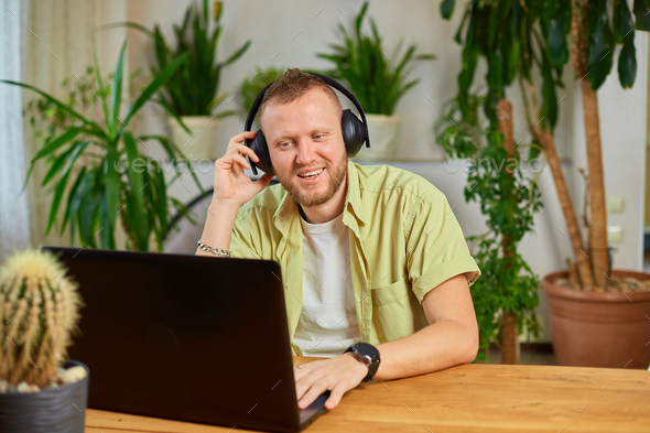 Man wearing headphones, study online education training, male student learning