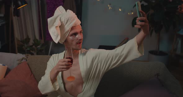 Trans Man in Home Wear Doing Selfie and Using Mobile Phone, Young Transgender Sitting on Sofa  alt