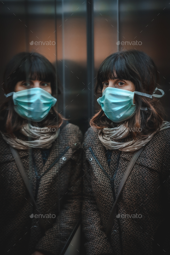 Health crisis, a sad young caucasian woman with a mask in a mirror