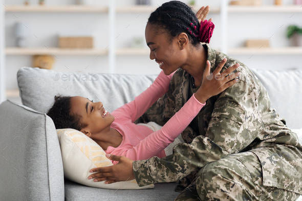 Female soldier waking up her kid, came back home