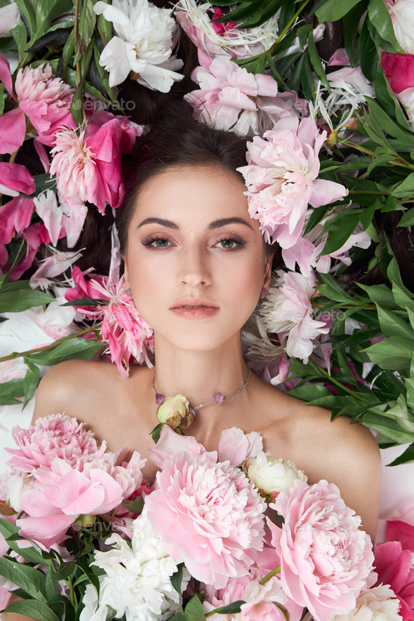 Beautiful Woman With Lots Of Pink Flowers In Her Hands Sexy Woman With Long Hair Stock Photo By