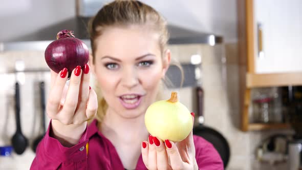 Woman Holds Red and White Onion alt