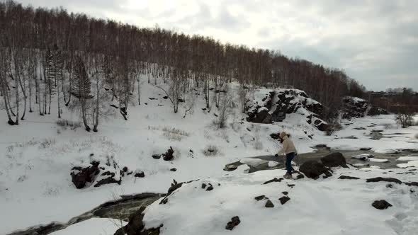 Video From the Height of a Girl Tourist Walks Through Snowcovered Mountains