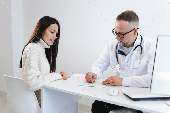 Doctor documents all the patient's complaints. Woman at the appointment in medical clinic