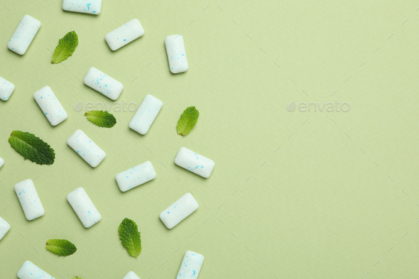 Chewing or bubble gum and mint on green background