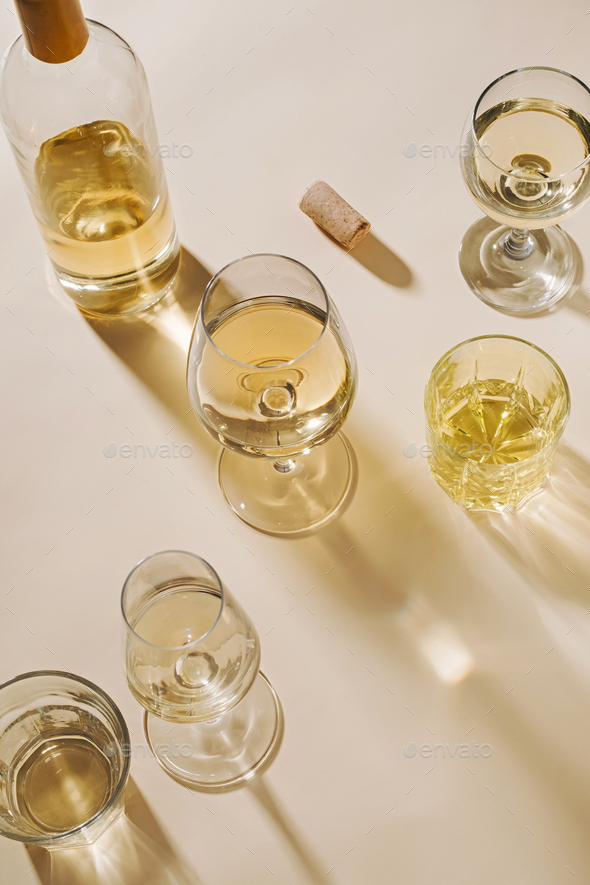 White wine served in assorted crystal glasses Stock Photo by sergign