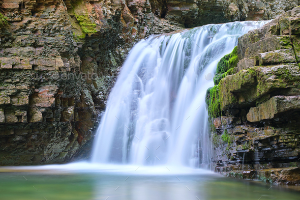 Amazing landscape of beautiful waterfall on mountain river with white ...