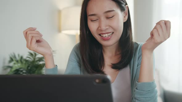 Asian Woman looking at a digital tablet screen Video call learning online on internet