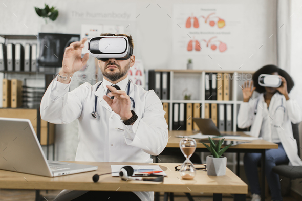 Multiracial medical workers using VR headset at cabinet
