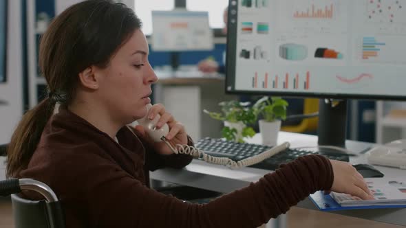 Paralysed Financial Woman Expert Sitting Immobilized in Wheelchair Speaking at Phone alt