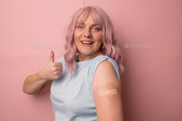 Coronavirus vaccinated woman showing thumb sign