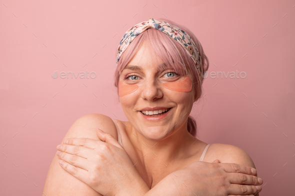 woman applying pink under eye patches for dark-circles and puffiness