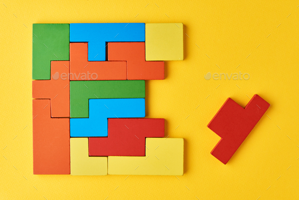 Logical thinking concept. Different shapes colorful wooden blocks on white background
