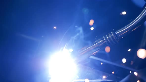 A Welding Process at a Plant. Welding Sparks, Slow Motion. alt