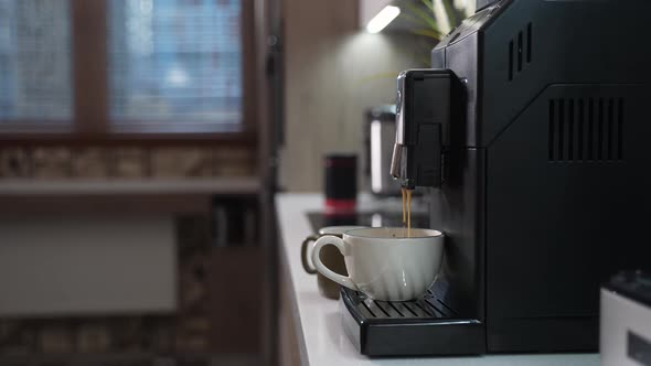 Automatic Coffee Machine Makes a Cup of Morning Coffee alt