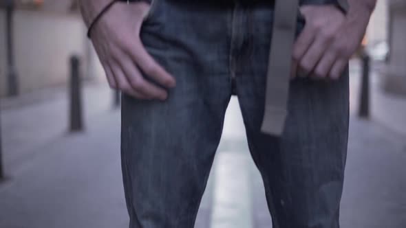 Camera Shows Young Backpacker Feet Then Reveals His Face with a Serious Look alt