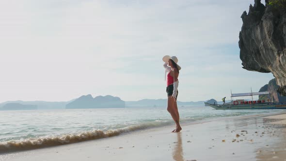 Woman Standing On Shore Of Entalula Beach alt