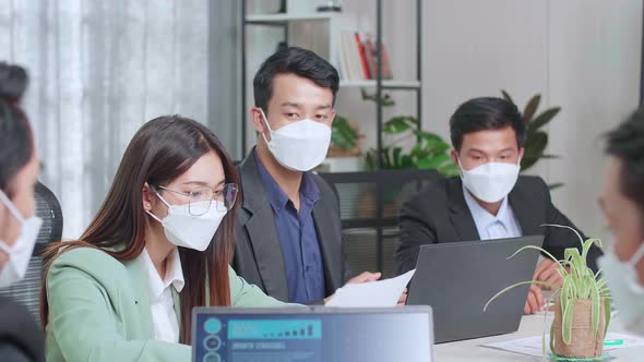 Asian Team Wearing Face Mask Have Meeting In A Conference Room. They Share Opinions alt