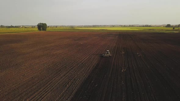 Aerial Drone Shot of a Farmer Spraying Soybean Fields