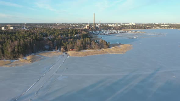 Beautiful Aerial Shot of the Frozen Sea and Factory Chimneys alt