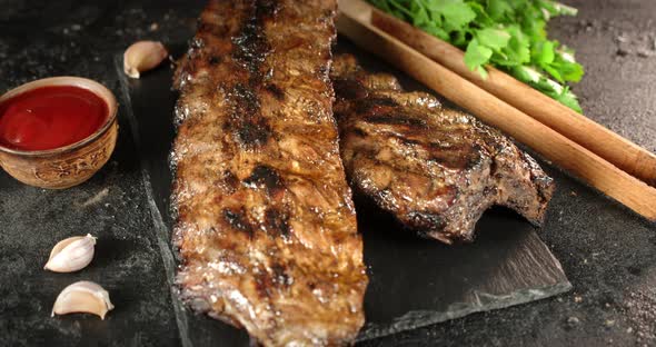 Grilled Ribs with Tomato Sauce Slowly Rotate.  alt