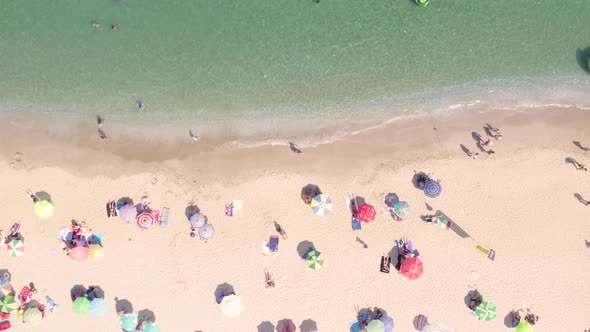 Top View of Sandy Beach with Turquoise Sea Water and Colorful Umbrellas alt