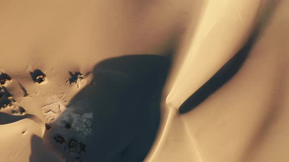 Top Down Aerial of Dunes in Golden Sunset Light Drone Above Scenic Landscape alt