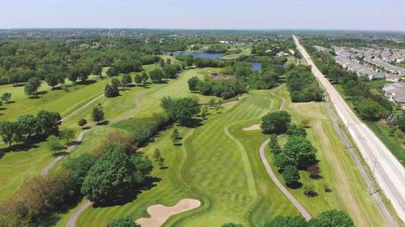 Aerial View From the Top n of the Golf Course, People and Cars on a Golf Course From a Height alt
