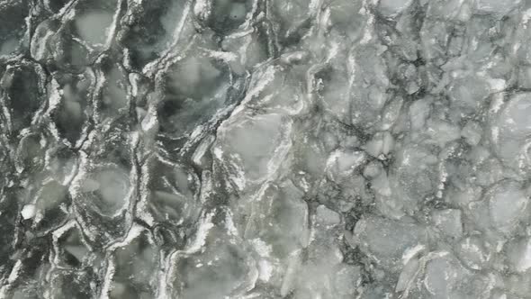 Ice sheets ripple with waves on lake alt