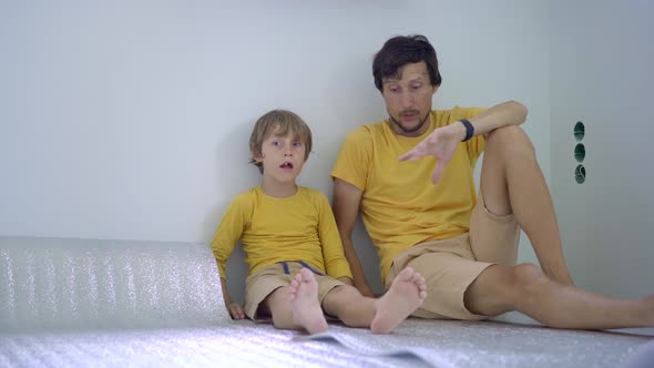 A Father an Son are Laying Out and Glue the Insulation for the Floor on Which They Will Then Lay the alt