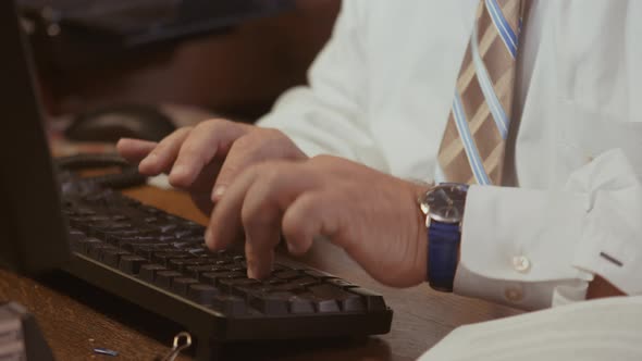 Business Man In Tie Typing At Computer