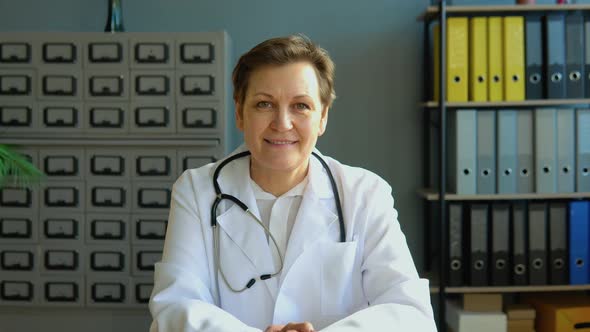 Portrait of a Senior Female Doctor Sitting in Her Office alt
