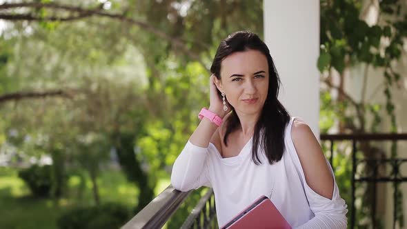 Female Realtor Waiting to Meet a Client Near the House alt