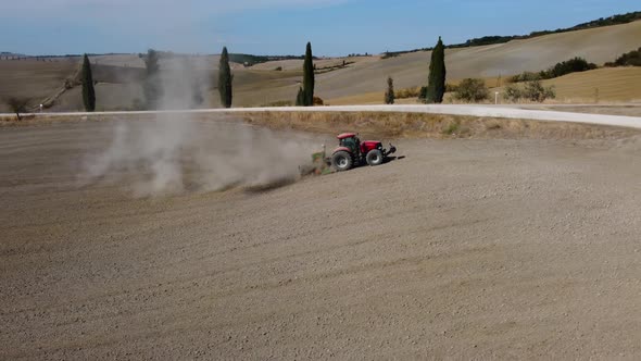Tractor Machinery Working Ground Soil in Countryside in Pienza, Tuscany