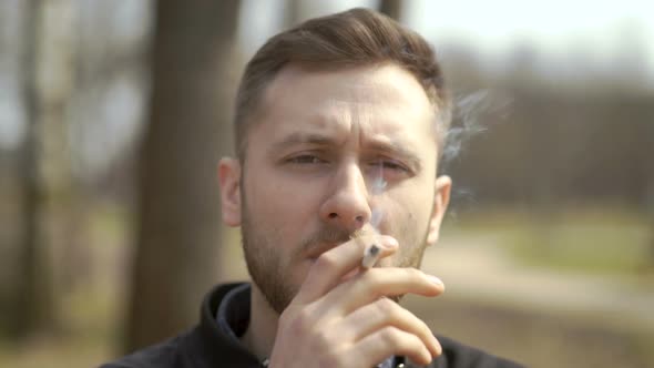 Person Lighting Up And Smoking Cigarette Outdoor