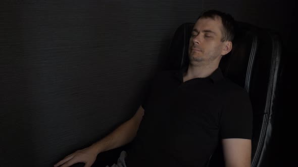 Man Lying Relax and Enjoying in Massage Chair in the Lounge Area in Airport alt