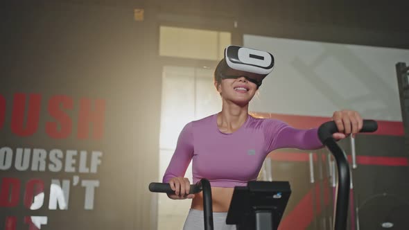 Asian young woman practice working out to maintaining muscle in gym or fitness club using machine. alt