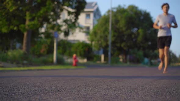 Slow Motion Shot of a Young Man Running Barefoot alt