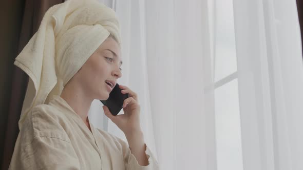 Young Woman with Towel on Head Making Phone Call alt