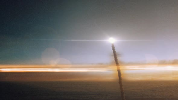Space Rocket Launching into Space Through the Clouds at Sunset