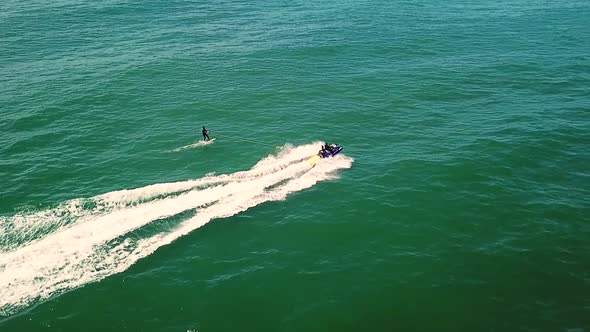 Aerial view of a surfer being towed with a jet ski near Cape Town, South Africa. alt