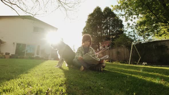 Little Toddler Child Boy Playing with Dog in Garden on Backyard alt