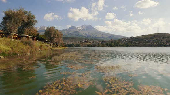 Drone Flies Forward Very Close to Lake Surface