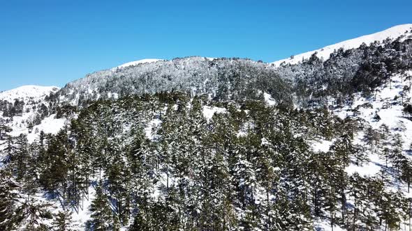 Moving over a snow covered mountain on a clear day