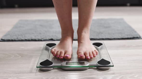 Female On Scales Measure Weight